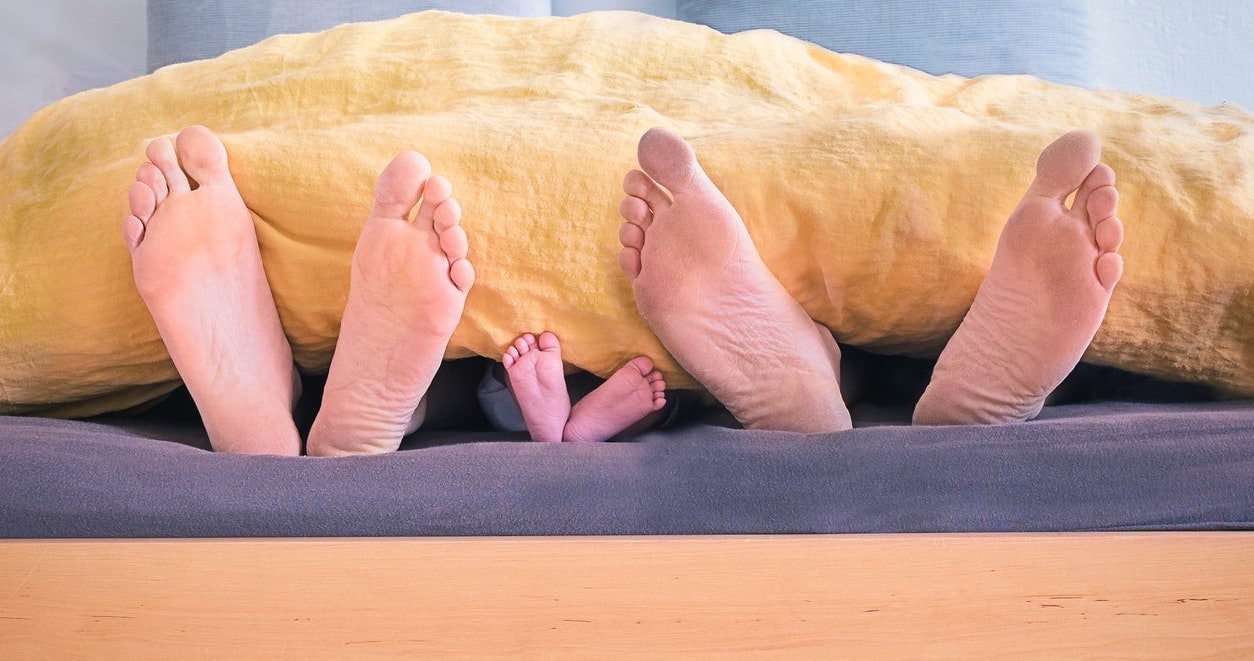 Close up of mom and baby’s feet after sleep training