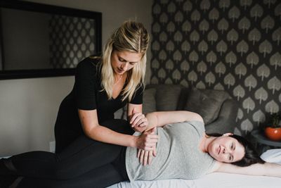 A Pelvic Floor Physiotherapist provides a prenatal treatment to a pregnant woman