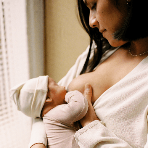 Woman is breastfeeding her newborn