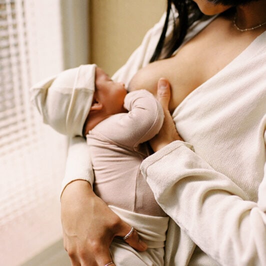 Latina mother breasfeeding her son