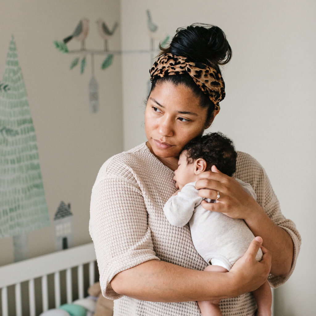 postpartum mom holding baby